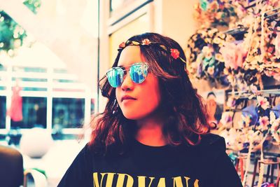 Girl wearing sunglasses and tiara in store