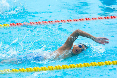 High angle view of young woman swimming in pool