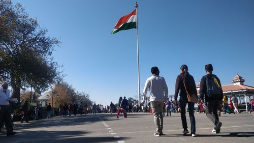 People on street in city against clear sky
