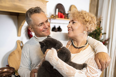 Portrait of senior couple with daughter at home