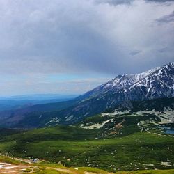 Scenic view of mountains against cloudy sky