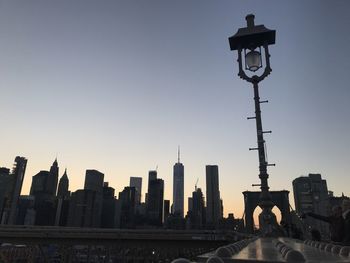 Street light in city against clear sky