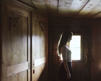 Full length of woman standing by railing