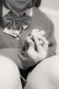 Close-up of cropped hand holding cigarette