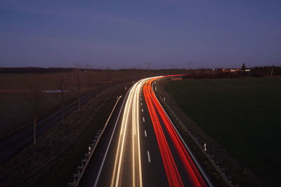 High angle view of light trails on road at night