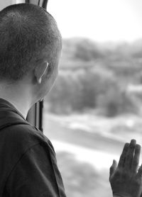 Rear view of man looking at camera