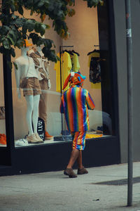 Rear view of woman standing in store