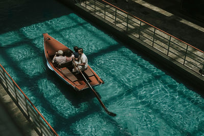 High angle view of people sitting in swimming pool