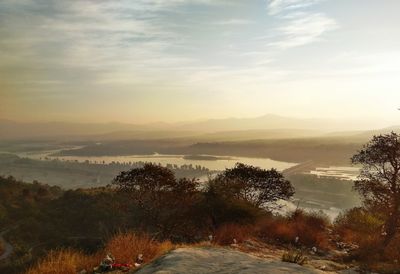 Scenic view of landscape against sky at sunset