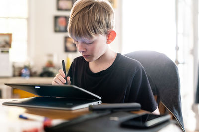 Boy with mobile phone at home