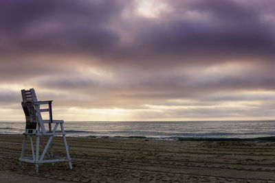 Scenic view of beach against cloudy sky