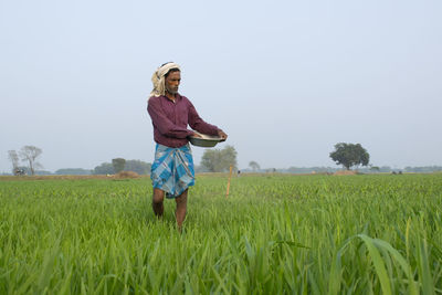 Full length of man standing in field