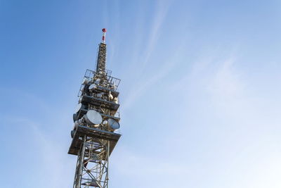 Low angle view of communications tower against sky
