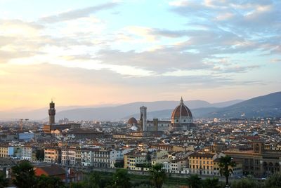 Duomo santa maria del fiore and buildings in city at sunset