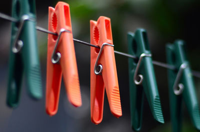 Close-up of clothespins hanging on clothesline