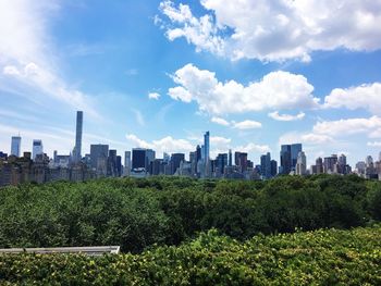 Modern cityscape against cloudy sky