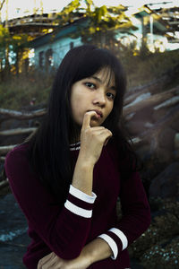 Portrait of teenage girl sitting outdoors