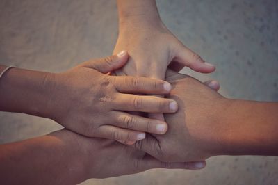 Directly above shot of friends stacking hands outdoors