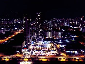 High angle view of city lit up at night
