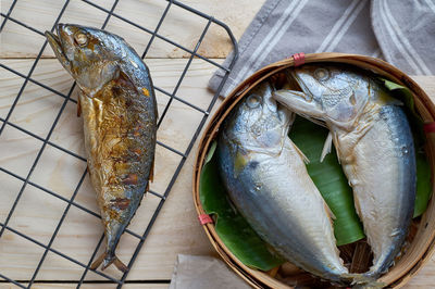 High angle view of boiled fish in container at table