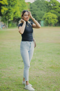 Young woman exercising on field