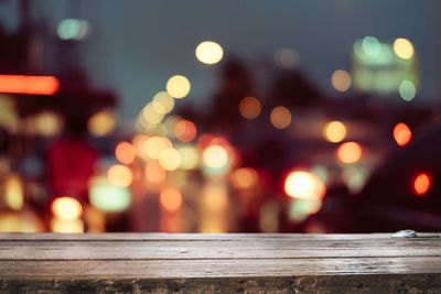 Defocused image of illuminated lights in city at night