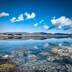 Scenic view of sea against blue sky