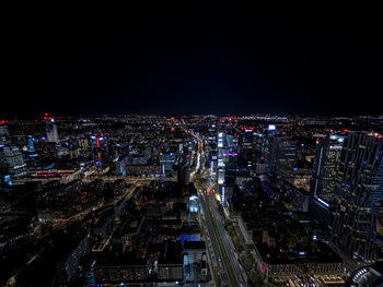 High angle view of illuminated cityscape against sky at night