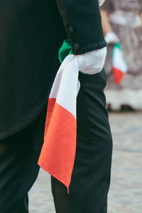Rear view of woman with umbrella standing against the sky