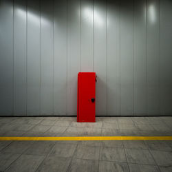 Red locker against gray wall