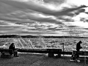 Silhouette of woman against cloudy sky