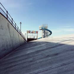 Crane on pier against blue sky