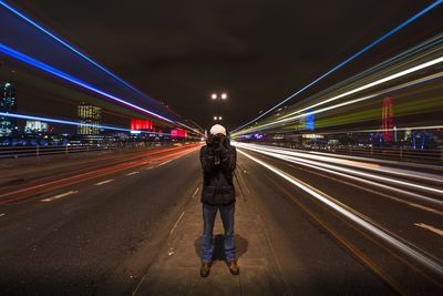 Blurred motion of people walking on road at night