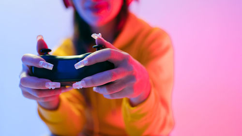 Midsection of woman using mobile phone