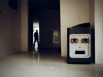 Full length of woman walking on tiled floor