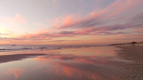 Scenic view of beach against dramatic sky