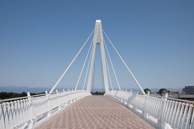 View of suspension bridge against clear blue sky