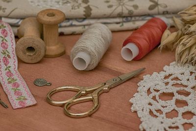 Close-up of sewing items on wooden table