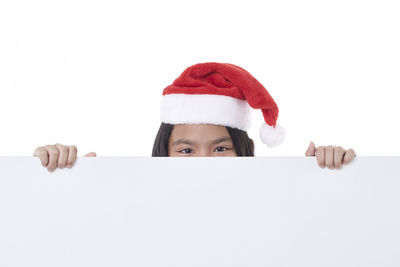 Portrait of girl holding flag against white background