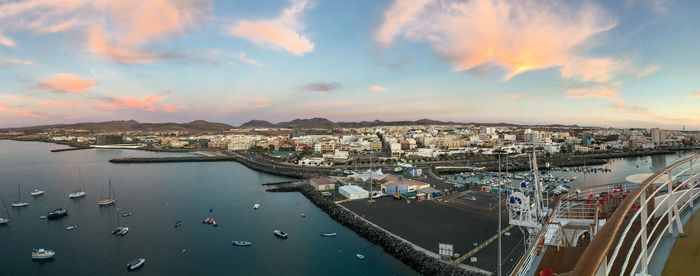Aerial view of cityscape against sky during sunset