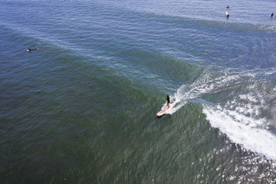 Aerial of woman surfing in summer