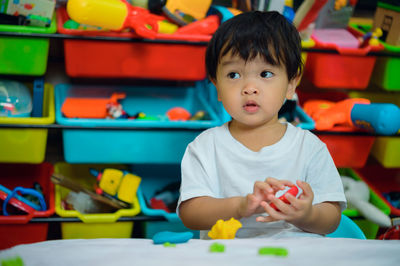 Portrait of cute boy playing on table