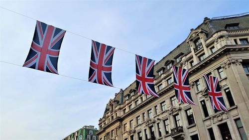 Low angle view of  the british flag on building against sky.