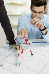 Professor guiding student in classroom