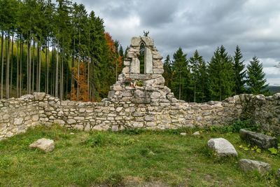 Ruins of temple against cloudy sky