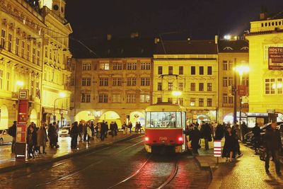 People walking on city street at night