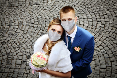 Portrait of young couple holding flower