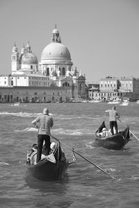 Rear view of man on boat at temple