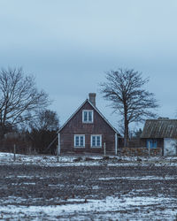 House on snow covered landscape