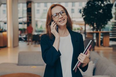 Portrait of young woman using mobile phone